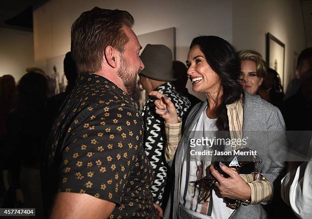 Actress Demi Moore greets photographer Brian Bowen Smith at the Brian Bowen Smith WILDLIFE show hosted by Casamigos Tequila at De Re Gallery on...