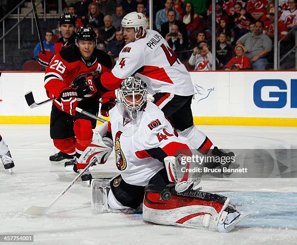 Robin Lehner of the Ottawa Senators makes the second period save as Patrik Elias of the New Jersey Devils looks for the rebound at the Prudential...