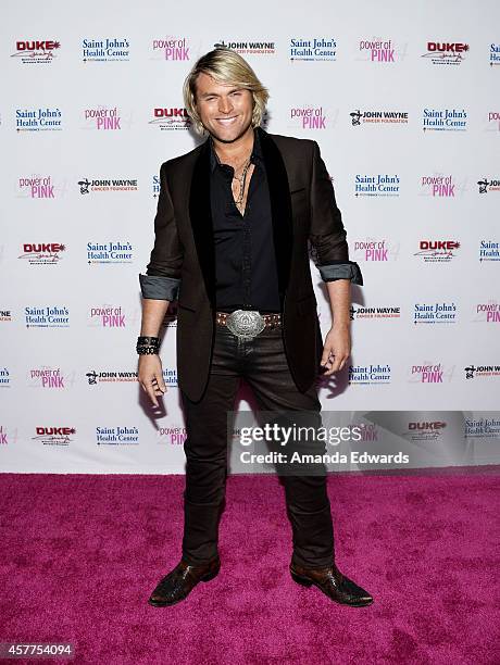 Singer Marcus Collins of the Texas Tenors arrives at the 2014 Power Of Pink: An Acoustic Evening With P!nk And Friends event at The House of Blues...