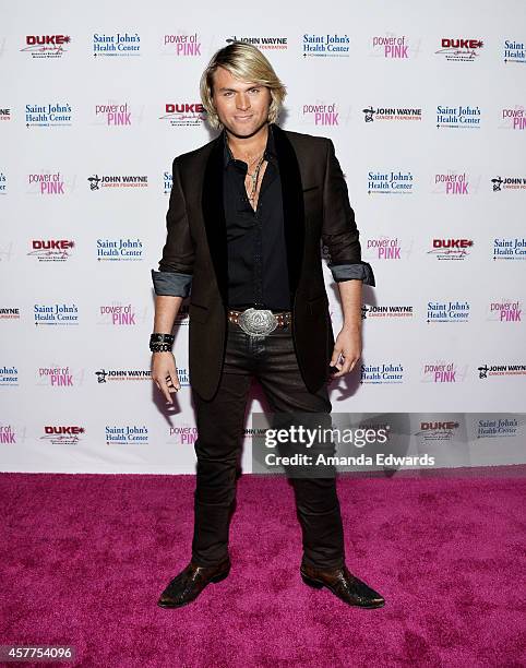 Singer Marcus Collins of the Texas Tenors arrives at the 2014 Power Of Pink: An Acoustic Evening With P!nk And Friends event at The House of Blues...