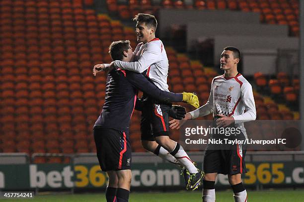 Goalkeeper Ryan Crump of Liverpool celebrates the team's penalty shoot out sucess with team matess Sergi Canos and Lloyd Jones during the FA Youth...
