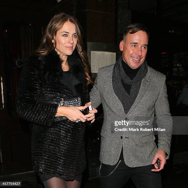 Elizabeth Hurley and David Furnish leave Colbert restaurant on December 18, 2013 in London, England.