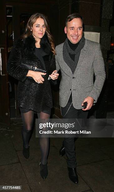 Elizabeth Hurley and David Furnish leave Colbert restaurant on December 18, 2013 in London, England.