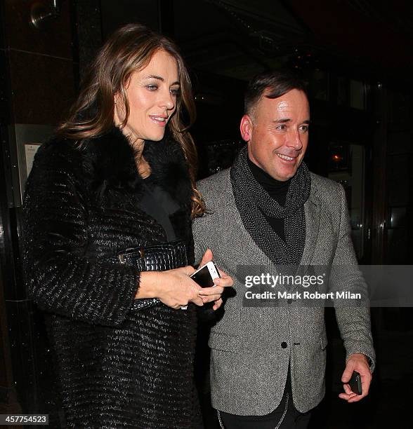 Elizabeth Hurley and David Furnish leave Colbert restaurant on December 18, 2013 in London, England.