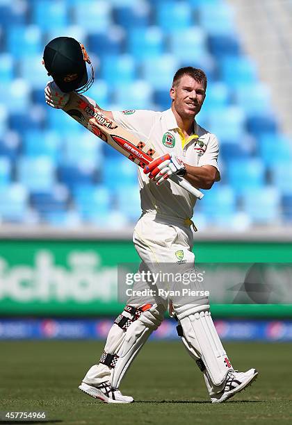 David Warner of Australia celebrates after reaching his century by signaling to his fiance and Candice Falzon and baby girl Ivy during Day Three of...