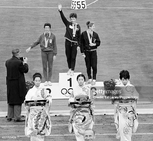 The medal presentation ceremony for the women's 800 metres event featuring, left to right: silver medallist Maryvonne Dupureur of France, gold...