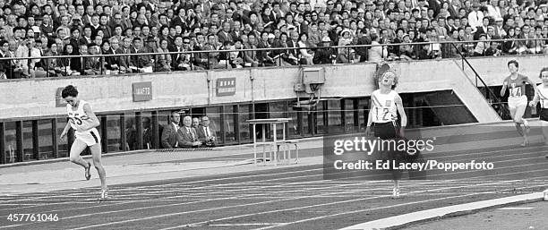 Australian athlete Betty Cuthbert finishes in first place to win the gold medal for Australia, ahead of Ann Packer of Great Britain, in the final of...
