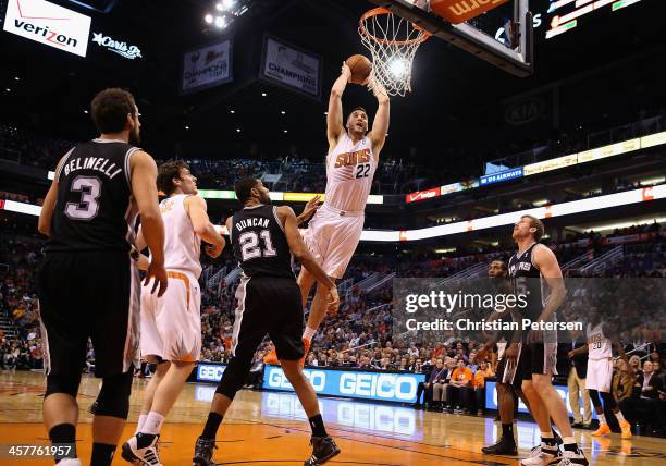 Miles Plumlee of the Phoenix Suns slam dunks the ball against the San Antonio Spurs during the first half of the NBA game at US Airways Center on...