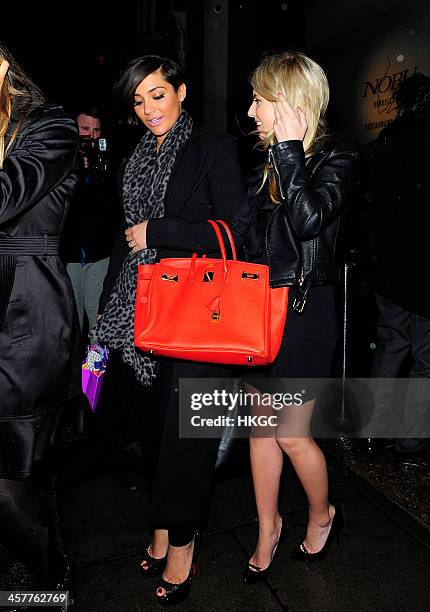 Frankie Sandford and Mollie King of The Saturdays leave Nobu Berkeley Street Sushi Restaurant on December 18, 2013 in London, England.