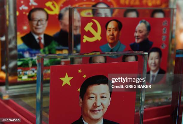 Decorative plaques featuring Chinese leaders of the past and present, including current president Xi Jinping are seen at a souvenir stall in Beijing...