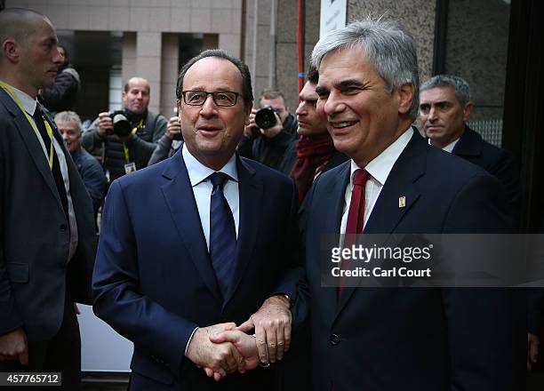 French President, Francois Hollande , greets the Chancellor of Austria, Werner Faymann, as they arrive at the headquarters of the Council of the...