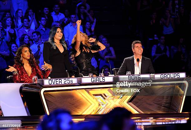 Judges Kelly Rowland, Demi Lovato, Paulina Rubio and Simon Cowell on FOX's "The X Factor" Season 3 Top 3 Live Finale Performance Show on December 18,...