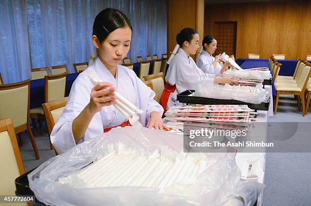 Shrine maidens pack 'Chitose Ame' candy in preparation for the Shichi-Go-San Festival at Takeda Shrine on October 23, 2014 in Kofu, Yamanashi, Japan....