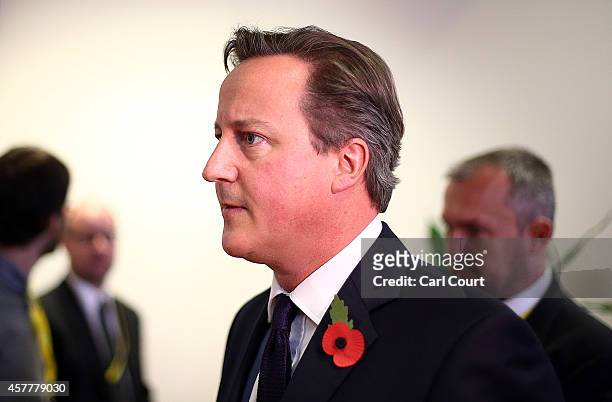 British Prime Minister David Cameron leaves after a press conference at the end of a two-day European Council meeting at the headquarters of the...