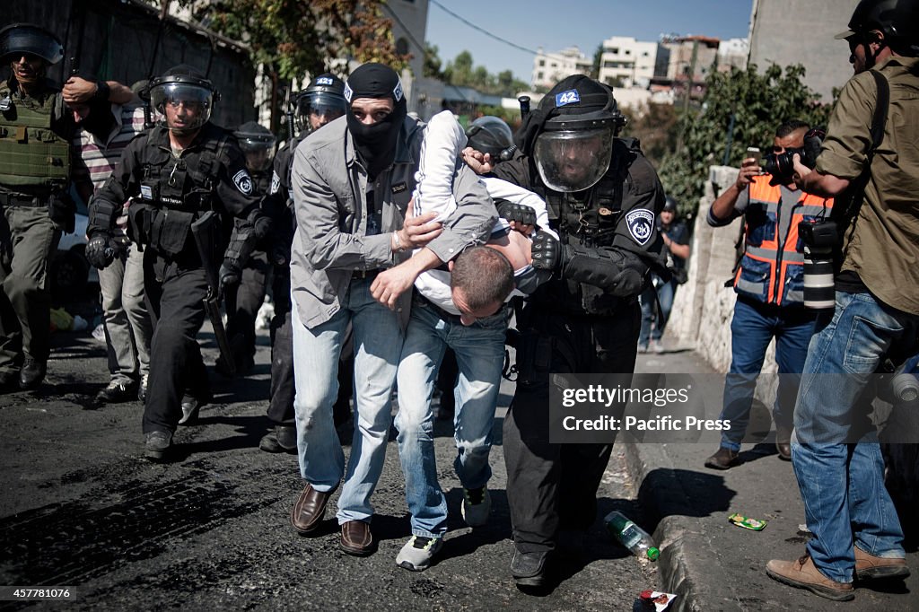 A police and undercover police men arrest a young...