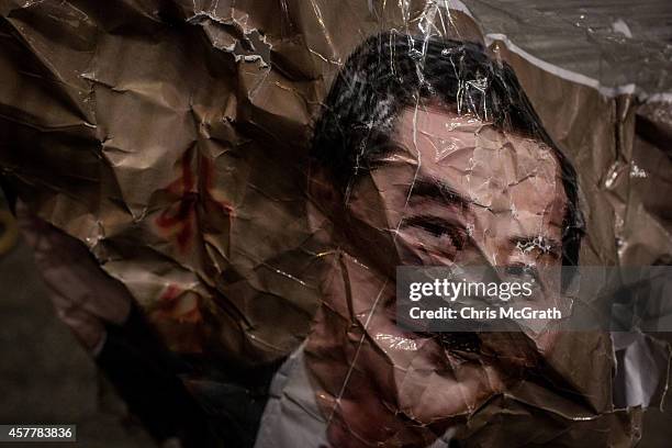 Poster of Hong Kong's Chief Executive C.Y Leung dressed as Adolf Hitler is seen on a barricade on a street in Mong Kok on October 24, 2014 in Hong...