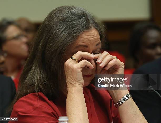 Deborah Burger, co-president of National Nurses United wipes he eyes during a House Oversight and Government Reform Committee hearing on Capitol...