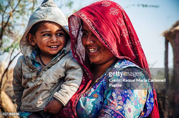 Portrait of Bishnoi tribal woman and son in their home in a village around Jodhpur.