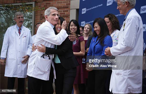 Director of the National Institute of Allergy and Infectious Diseases Anthony Fauci hugs Nina Pham , the nurse who was infected with Ebola from...