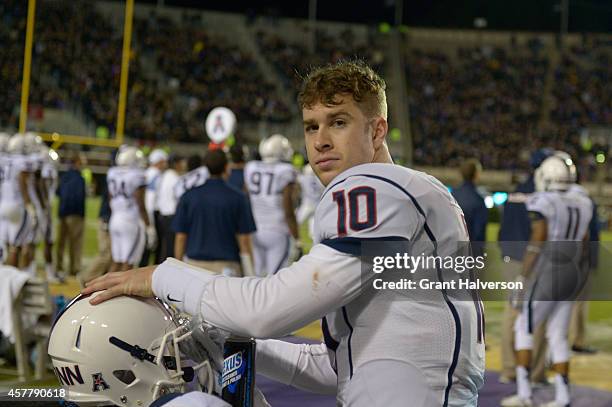 Quarterback Chandler Whitmer of the Connecticut Huskies cleans his hemet visor during their game against the East Carolina Pirates at Dowdy-Ficklen...