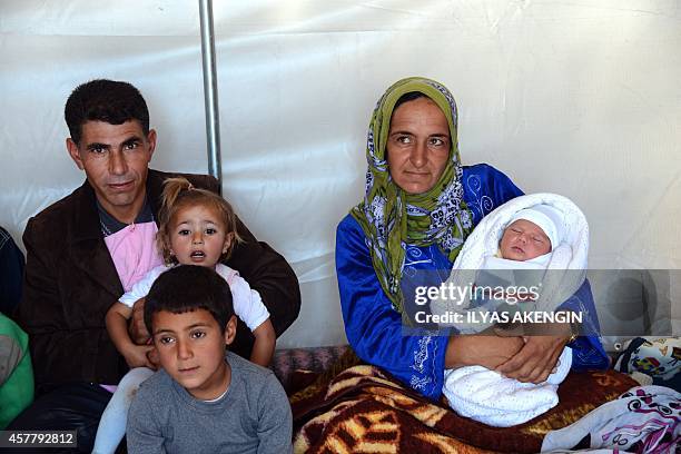 Sultan Muslim and her husband Mahmut Beko Muslim pose with their children, including their newborn son Muhammed Obama Muslim, at Suruc Rojava refugee...