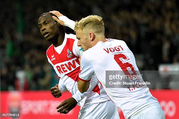 Anthony Ujah of Koeln celebrates with teammate Kevin Vogt of Koeln after scoring the opening goal during the Bundesliga match between SV Werder...