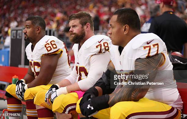 Guard Chris Chester, center Kory Lichtensteiger and guard Shawn Lauvao of the Washington Redskins on the bench during the NFL game against the...