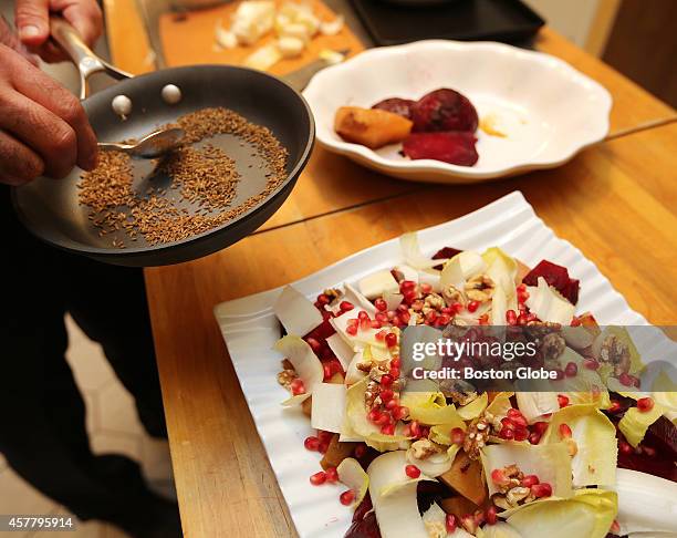 Toasted cumin seeds are sprinkled on Beet and Endive Salad. Mohammed Fotouhi prepares dishes for Thanksgiving, on Wednesday, October 23, 2013.