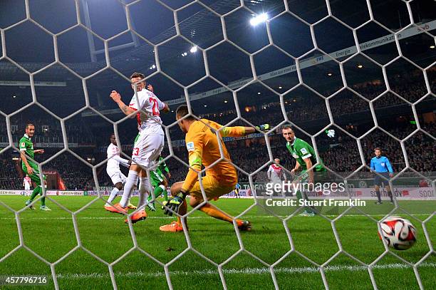Anthony Ujah of Koeln scores the matchwinning goal past goalkeeper Raphael Wolf of Werder Bremen during the Bundesliga match between SV Werder Bremen...