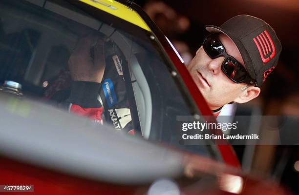 Jeff Gordon, driver of the Drive To End Hunger Chevrolet, climbs into his car in the garage area during qualifying for the NASCAR Sprint Cup Series...
