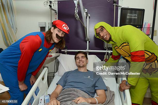 Boston Celtics Kelly Olynyk and Evan Turner spend time with John at Boston Children's Hospital October 24, 2014 in Boston, Massachusetts.