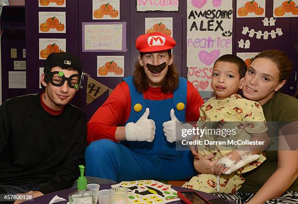 Boston Celtics Kelly Olynyk spends time Joseph, Mom and Dad at Boston Children's Hospital October 24, 2014 in Boston, Massachusetts.