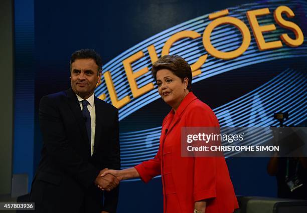 Presidential candidate for the Brazilian Workers' Party and current President Dilma Rousseff shakes hands with the presidential candidate for...