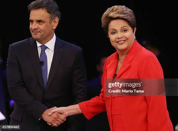 Brazilian President and Workers' Party candidate Dilma Rousseff stands with Presidential candidate of the Brazilian Social Democratic Party Aecio...