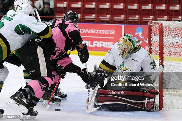 Etienne Montpetit of the Val D'Or Foreurs stops the puck on an attempt by Danick Martel of the Blainville-Boisbriand Armada during the QMJHL game at...