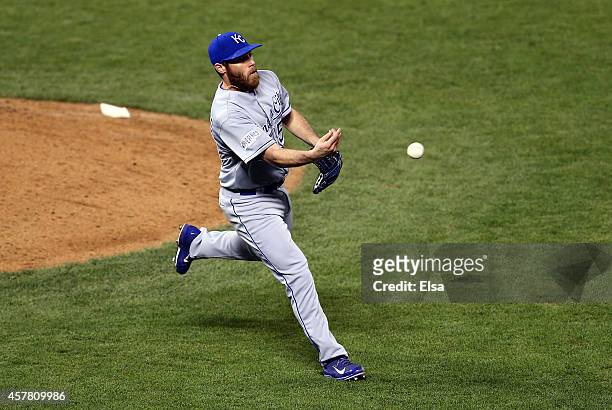 Greg Holland of the Kansas City Royals underhands the ball for the final out in the ninth inning during Game Three of the 2014 World Series at AT&T...