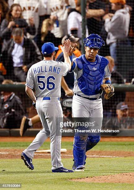 Salvador Perez and Greg Holland of the Kansas City Royals celebrate the Royals 3-2 victory against the San Francisco Giants during Game Three of the...
