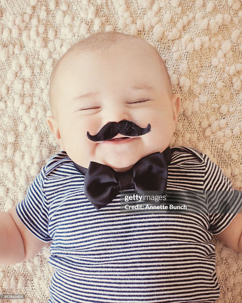 Squinty eyed baby with mustache