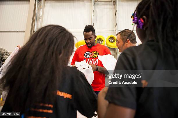 Washington Wizards player Martell Webster helps pack bags at the Capital Area Food Bank in support of the Weekend Bag Program in Washington, D.C. On...