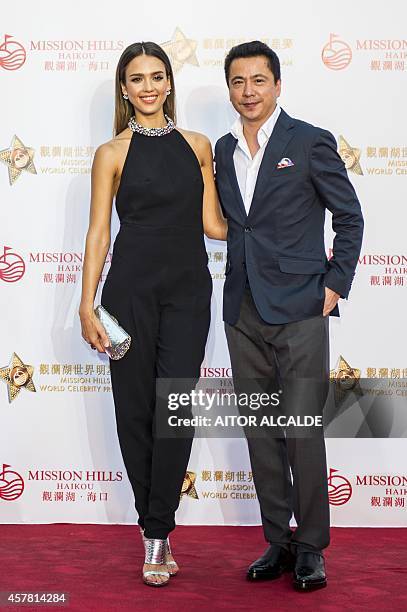Actress Jessica Alba and Huayi Brothers President Wang Zhonglei pose on the red carpet during the Opening Ceremony in Haikou ahead of the Mission...