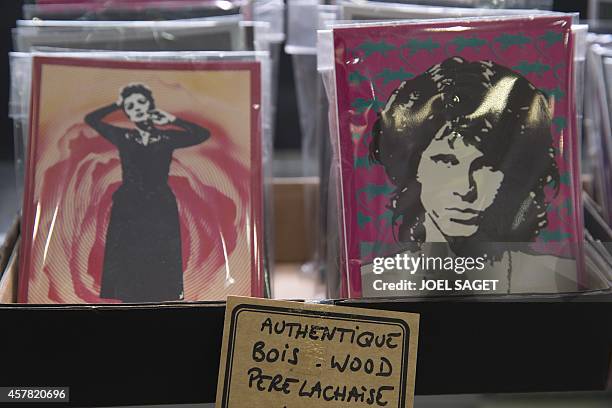 Picture postcards depicting late French singer Edith Piaf and late US singer Jim Morrison displayed in a souvenirs shop in the Pere-Lachaise cemetery...
