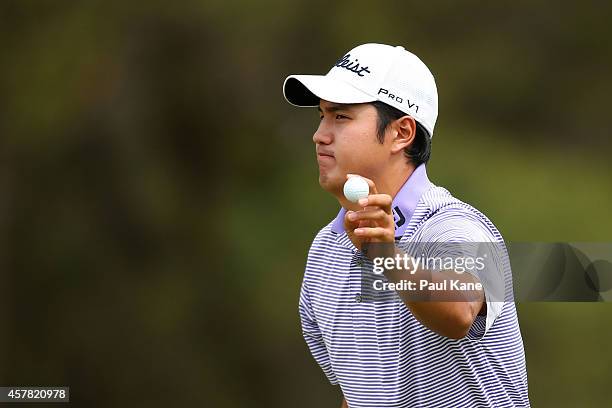 Sihwan Kim of Korea acknowledges the gallery after an eagle on the 14th hole during day three of the 2014 Perth International at Lake Karrinyup...