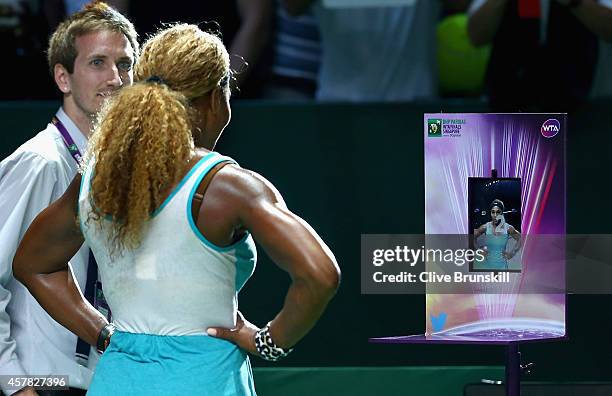 Serena Williams of the United States tweets a photo after her three set victory against Caroline Wozniacki of Denmark in their semi final match...