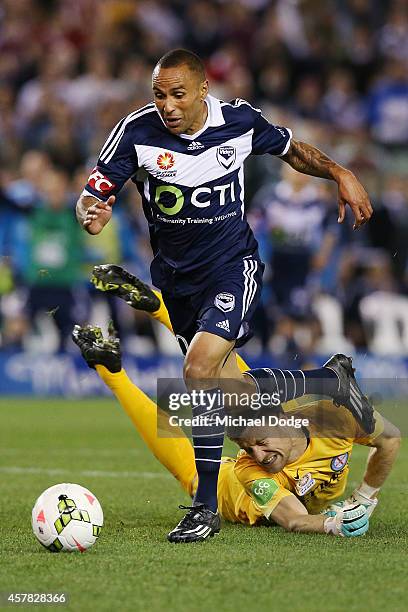 Archie Thompson of the Victory dribbles the ball past keeper Andrew Redmayne of Melbourne City to kick a goal during the round three A-League match...