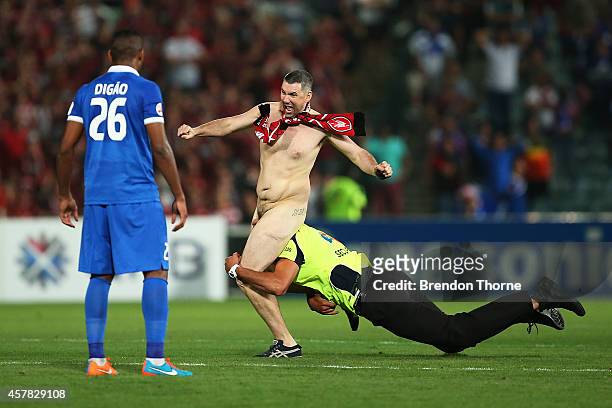 Pitch invader runs onto the field during the Asian Champions League final match between the Western Sydney Wanderers and Al Hilal at Pirtek Stadium...
