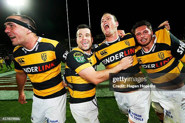 To R, Leighton Price, James Marshall, James Broadhurst and Mitchell Brown of Taranaki celebrate winning the ITM Cup Premiership Final match between...