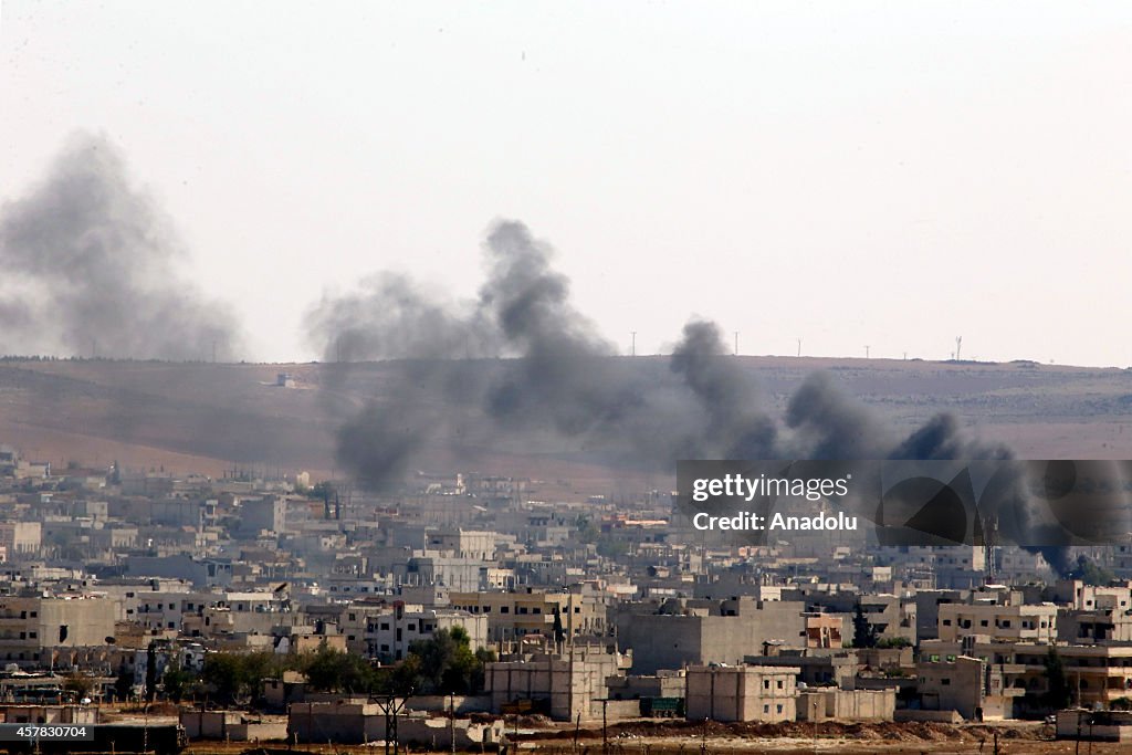 Smoke rises during clashes between ISIL and armed groups