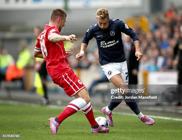 Lee Martin of Millwall takes the ball past Anthony Pilkington of Cardiff during the Sky Bet Championship match between Millwall and Cardiff City at...