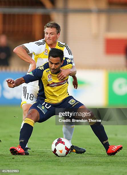 Marcos Flores of the Mariners competes with Ben Sigmund of the Phoenix during the round six A-League match between the Central Coast Mariners and...