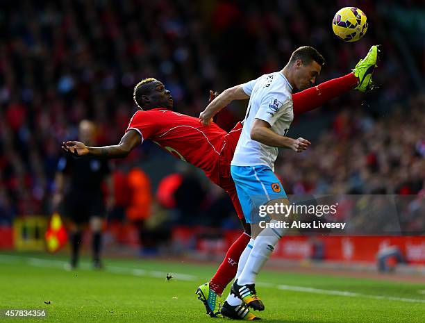 Mario Balotelli of Liverpool is challenged by James Chester of Hull City during the Barclays Premier League match between Liverpool and Hull City at...